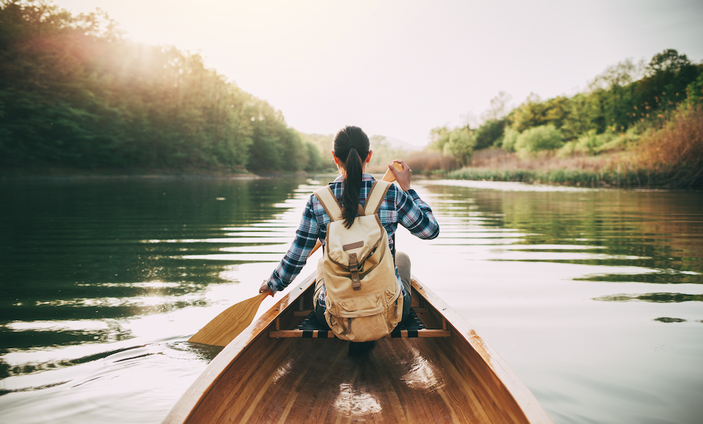 Girl rowing a canoe